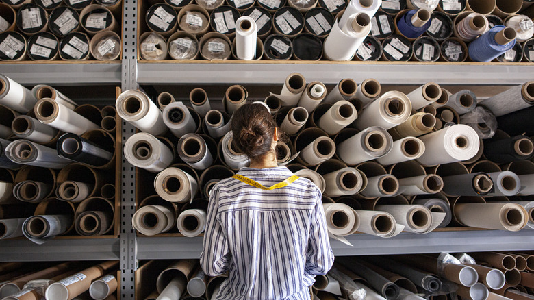 woman and fabric rolls