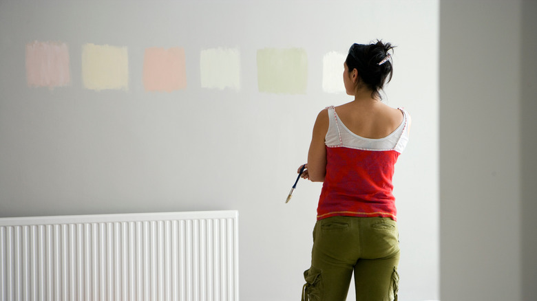 woman painting paint swatches