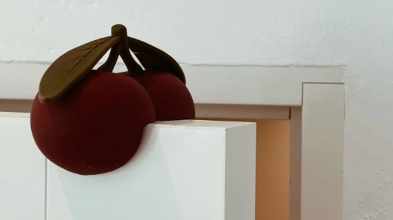 Cherry doorstop slung over door