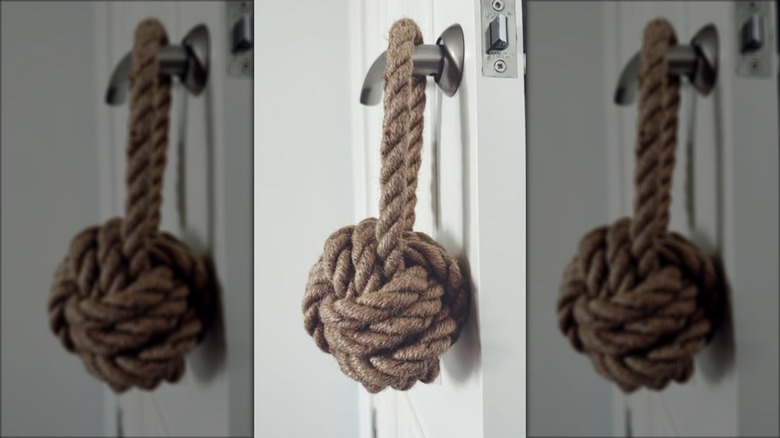 Macrame knot doorstop over handle