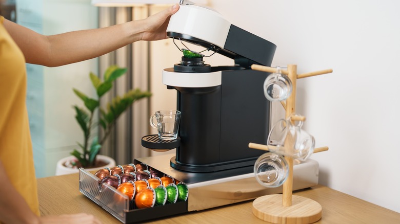 person using coffee pod machine