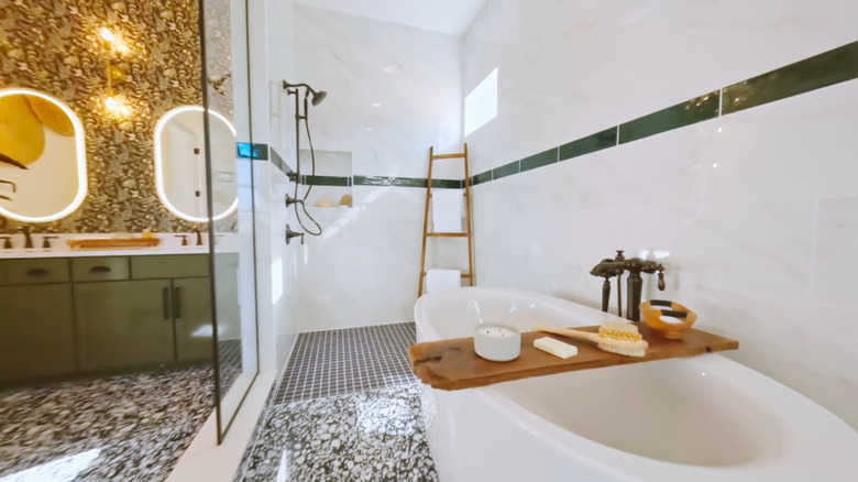 A bathtub in a luxurious marble shower