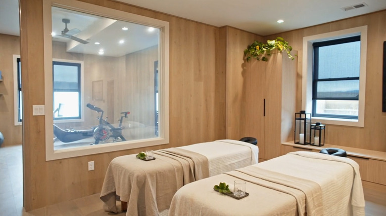 Two massage tables in a lower-level wellness area