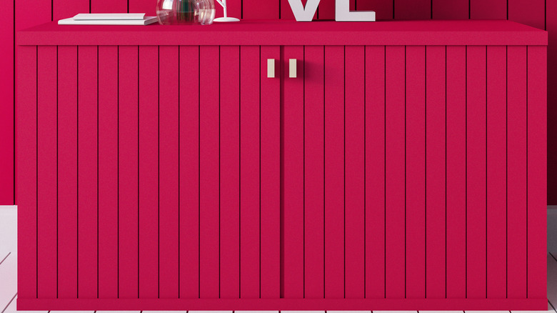 The color viva magenta on a bathroom cabinet