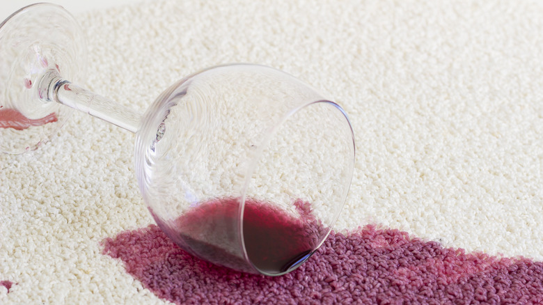 Red wine stain on a white carpet 