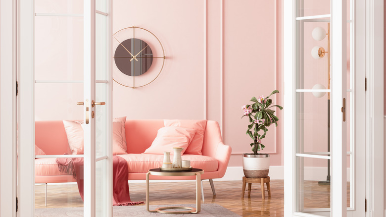 blush pink couch with pink wall 