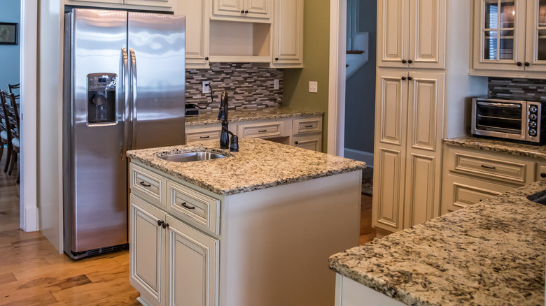 traditional kitchen with beige granite countertops