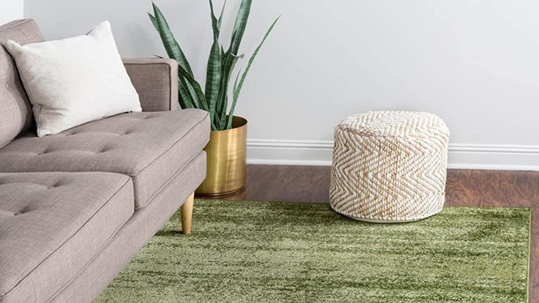 olive green rug in neutral room