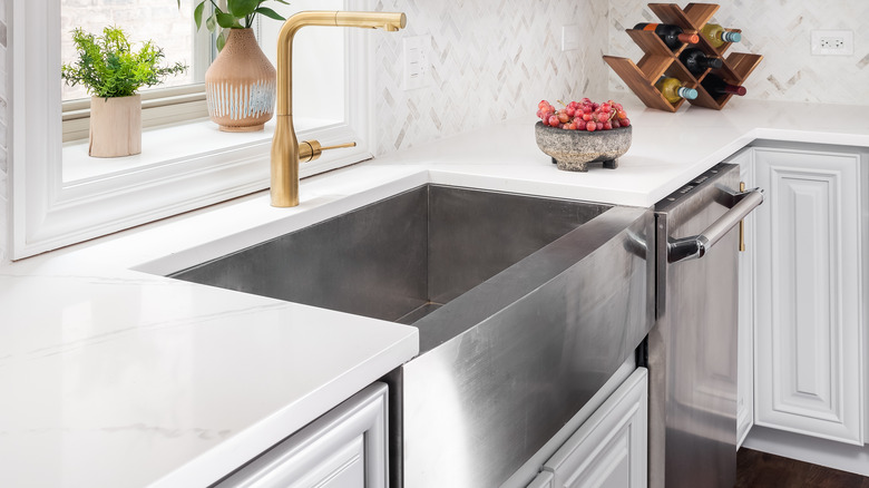 stainless steel sink in white kitchen