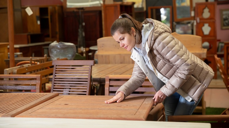 Person picking wood furniture