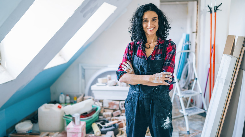 woman surrounded by clutter in attic