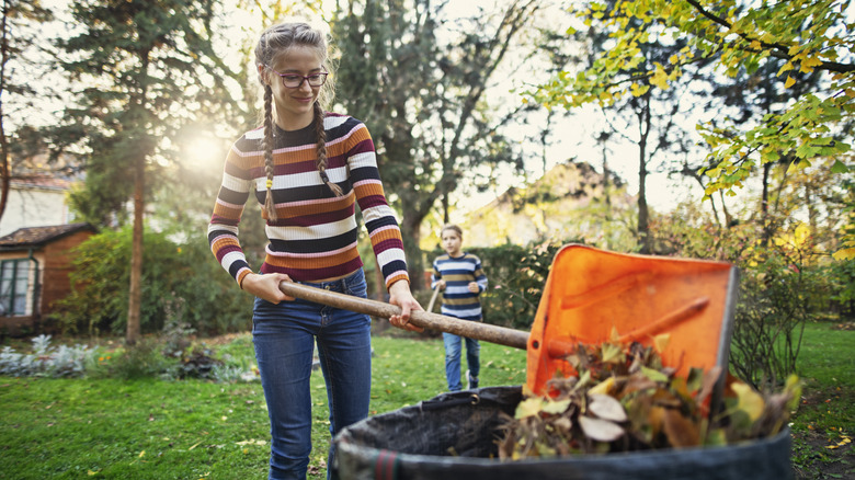 woman cleaning yard