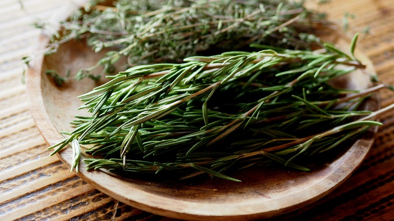 rosemary stems in wooden bowl