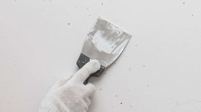 Person covering nail holes