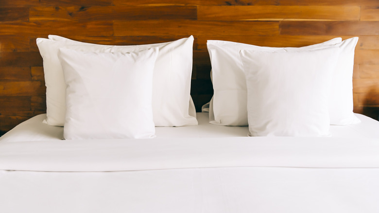 Pillows on white bed