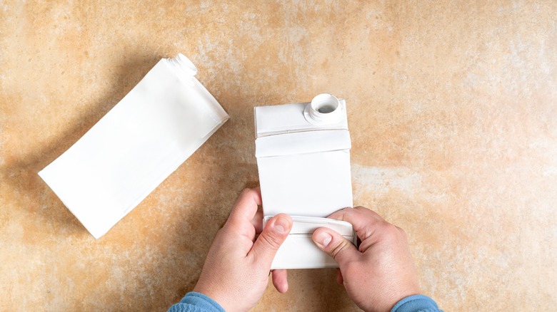 person folding cartons