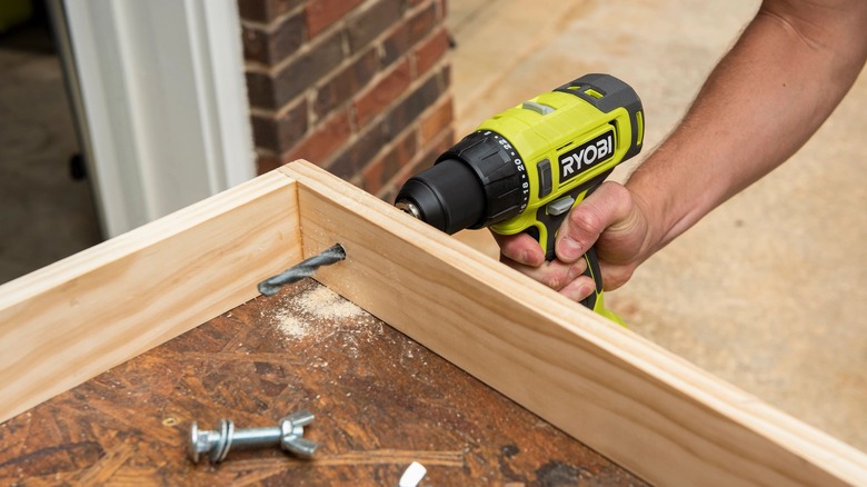 person using a Ryobi cordless power drill