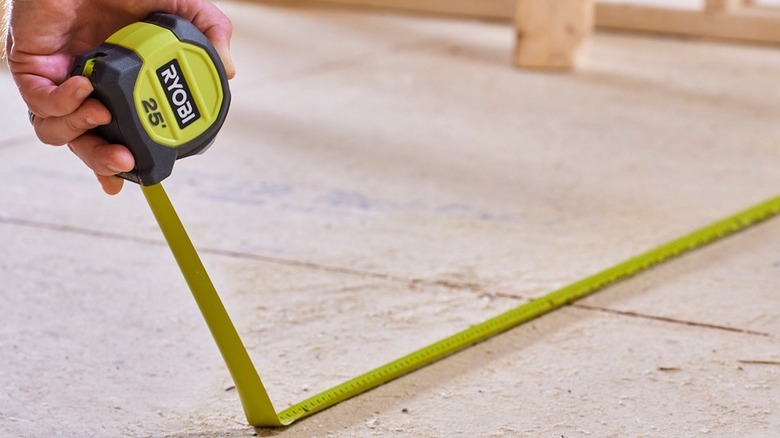 person using a tape measure