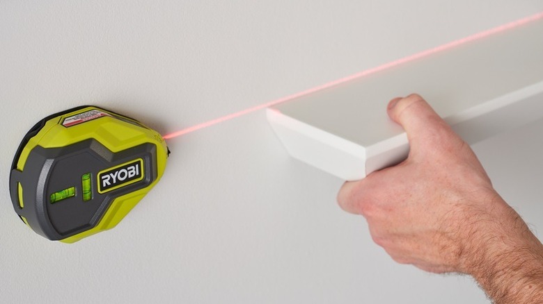 person using a laser level