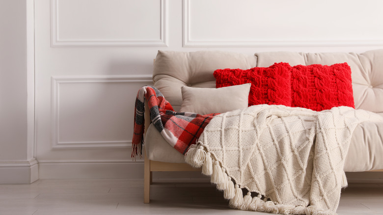 red pillows on tan sofa 