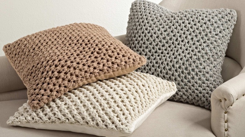 three different color knitted throw pillows