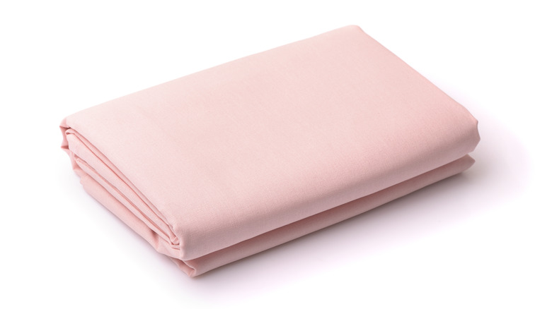 pink folded bed sheet