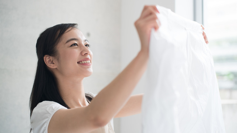 Woman smiling at wrinkle-free shirt