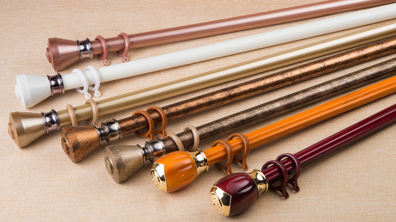 several assorted curtain rods on tan background