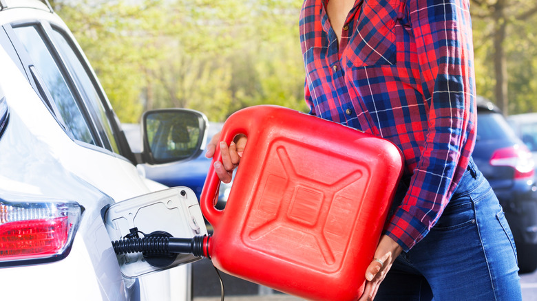 woman filling up car with gas