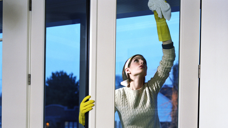 woman cleaning glass doors