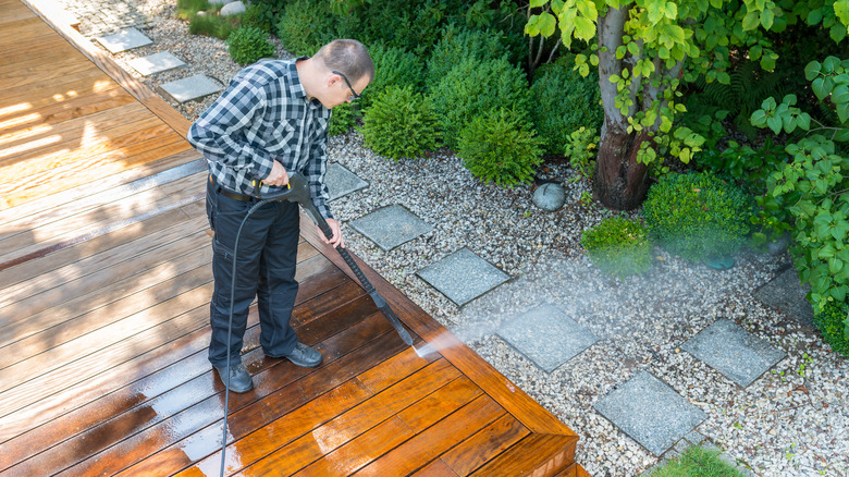 man power washing the deck