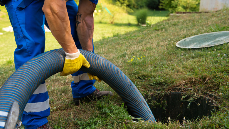 man emptying septic tank