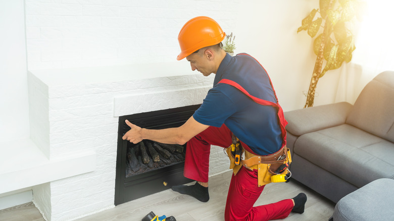 technician installing fireplace