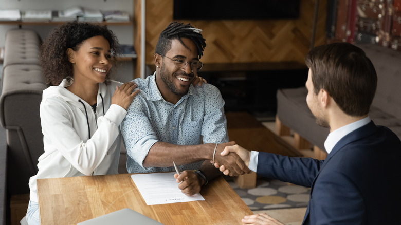 Couple smiling after signing contract