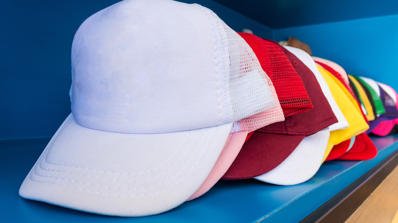 baseball hats on shelf