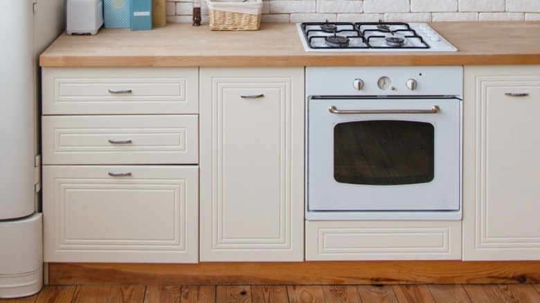 oven surrounded by white cabinets