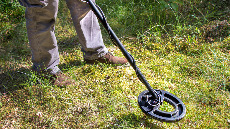 person with metal detector 