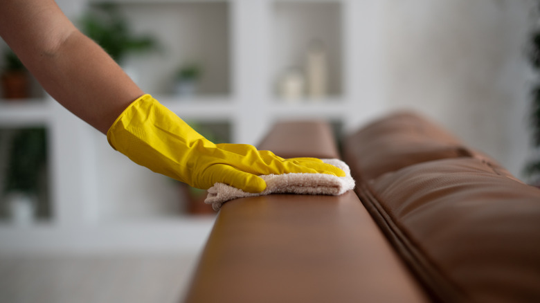 person cleaning leather