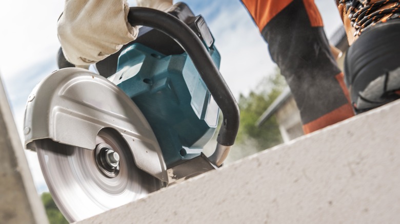 Person cutting a board with a circular saw