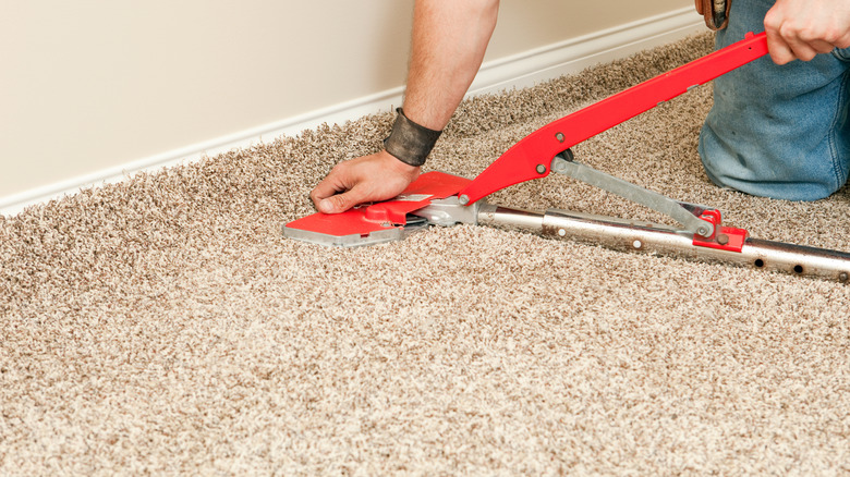 Person installing carpet