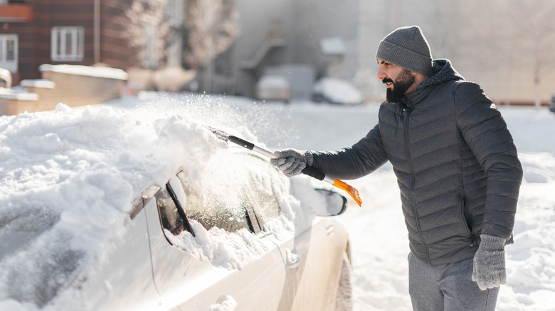 Person removing ice from windshield