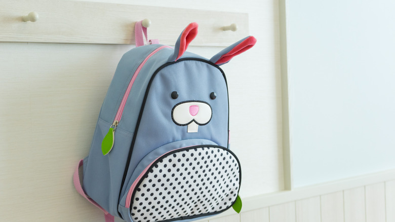 child's backpack hanging on hook