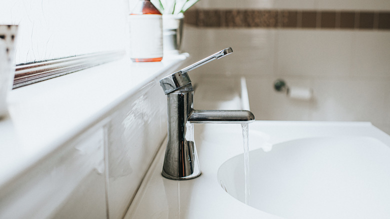 Bathroom sink with faucet running