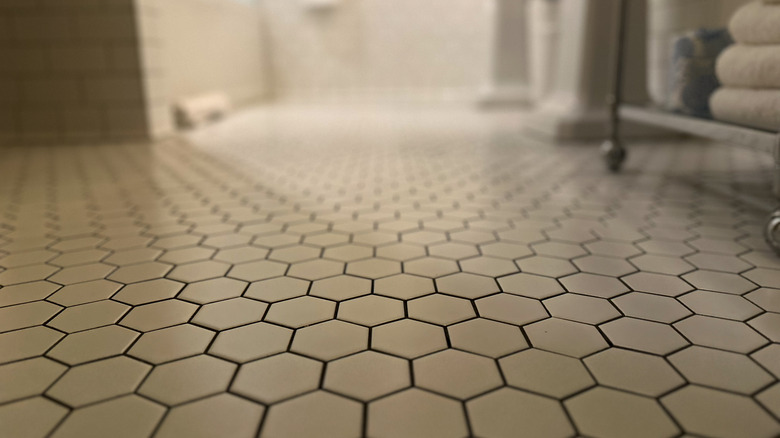 Close-up of hexagonal white floor tiles in bathroom