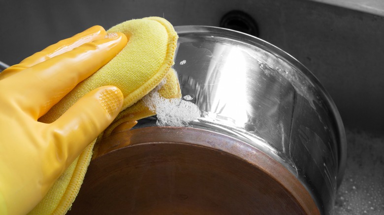 Person cleaning pot