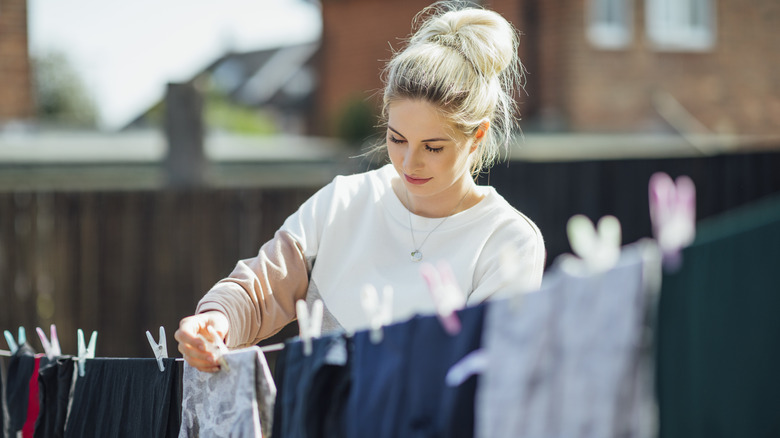 woman line drying clothes