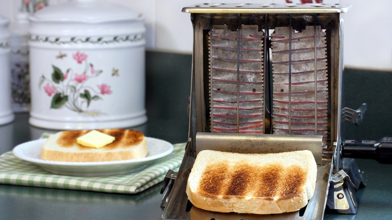 Old-fashioned vintage toaster toasting bread