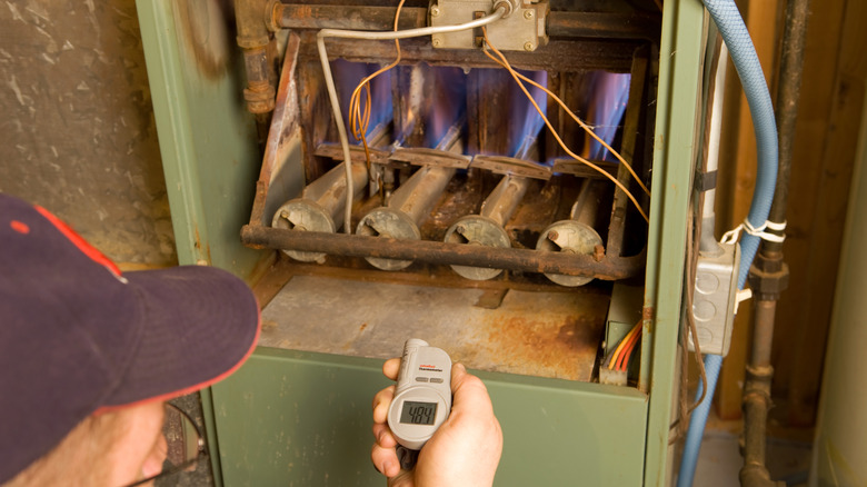 Technician inspecting a furnace