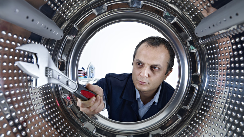 man working on washing machine