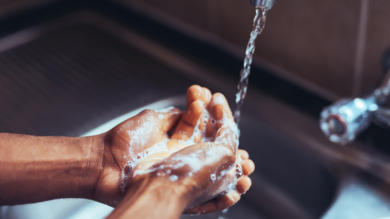 Person washing their hands with water